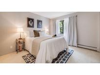 Bright bedroom featuring a comfortable bed, stylish decor, and a window with natural light at 7770 W 38Th Ave # 207, Wheat Ridge, CO 80033
