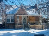 Brick home with covered porch and steps, needs repairs at 1274 Hudson St, Denver, CO 80220