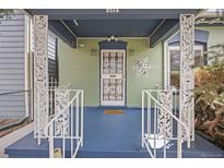 Charming front porch with decorative railings and blue painted floor offers a welcoming entrance at 2514 N Humboldt St, Denver, CO 80205