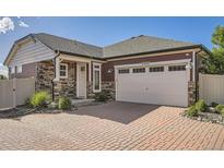 Charming home featuring stone accents, siding, and a brick driveway to the attached two car garage at 4955 N Picadilly Ct, Aurora, CO 80019