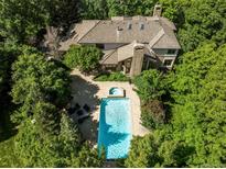 Stunning aerial view of the property featuring a pool, spa, patio, and lush landscaping at 5550 Preserve Dr, Greenwood Village, CO 80121