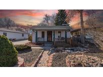 Charming bungalow with a cozy front porch, desert xeriscape and brick walkway at 437 Raleigh St, Denver, CO 80204