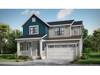 Inviting two-story home with a blend of blue and gray siding, complemented by a covered front porch and attached garage at 39765 Gibson St, Elizabeth, CO 80107