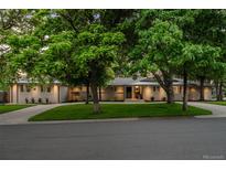 Charming single-story home with a well-manicured front lawn and mature trees at 3901 S Dexter St, Cherry Hills Village, CO 80113