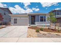 Charming single Gathering home features modern curb appeal and attached two car garage at 8317 Snake River St, Littleton, CO 80125