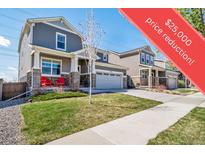 Charming two-story home with front yard, stone accents, and a driveway leading to a two-car garage at 17382 Bluetrail Ave, Parker, CO 80134
