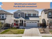 Charming two-story home featuring a two-car garage, stone accents, and a well-maintained front yard at 17382 Bluetrail Ave, Parker, CO 80134