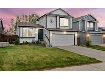 Charming two-story home features a well-manicured lawn, two-car garage, and inviting front entrance at 9677 Castle Ridge Cir, Highlands Ranch, CO 80129