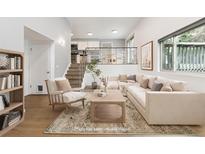 Bright living room featuring neutral tones, stylish furniture, and a modern design at 2492 S Yarrow St, Lakewood, CO 80227