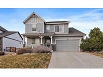 Two-story Craftsman-style home with gray siding, and a two-car garage at 8695 Torrey St, Arvada, CO 80007