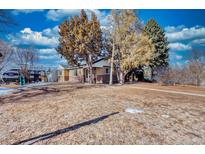 Ranch style home with spacious yard and mature trees at 6825 E Martin Luther King Jr Blvd, Denver, CO 80207