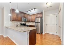 Modern kitchen with stainless steel appliances and granite countertops at 1162 Rockhurst Dr # 201, Highlands Ranch, CO 80129