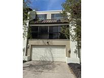Inviting two-story townhome featuring an attached garage and charming balcony with wrought iron details at 935 N Pennsylvania St # 3, Denver, CO 80203