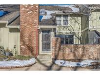 Brick front exterior of townhome with steps leading to the entrance at 11733 Elk Head Range Rd, Littleton, CO 80127