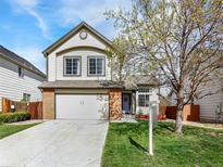 Charming two-story home with a well-maintained front yard and a two-car garage at 718 Fairhaven St, Castle Rock, CO 80104