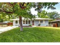 Charming single-story home with a well-manicured lawn and mature trees at 1215 S Ivanhoe Way, Denver, CO 80224