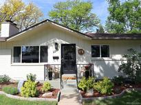 Charming single-story home with a well-manicured front yard and inviting entrance in a sunny landscape at 2237 Zinnia St, Golden, CO 80401