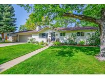 Charming single-story home with a well-manicured lawn and mature trees offering shade at 2237 Zinnia St, Golden, CO 80401