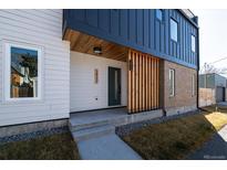 Modern exterior with a combination of textures and colors featuring a welcoming porch and sleek design elements at 3432 W 25Th Ave, Denver, CO 80211
