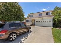 Charming two-story home featuring a spacious front yard, a two-car garage, and a well-maintained lawn at 19917 Mitchell Cir, Denver, CO 80249