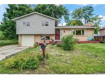 Charming two-story home with a brick and wood facade, and a well-maintained front yard and inviting front porch at 1161 S Johnson Way, Lakewood, CO 80232