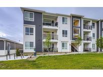 Modern apartment building with a striking two-tone color scheme and private balconies at 6153 N Ceylon St # 2-202, Denver, CO 80249