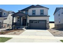 Charming two-story home features a covered porch, two-car garage, and low maintenance landscaping at 11008 Snowdon St, Parker, CO 80134