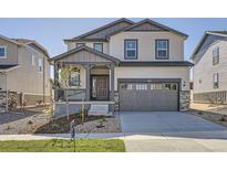 Charming two-story home with a covered porch and two-car garage showcasing great curb appeal at 11008 Snowdon St, Parker, CO 80134