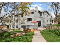 Beautifully landscaped condo exterior with mature trees and inviting walkways on a sunny day at 8500 E Jefferson Ave # 11C, Denver, CO 80237