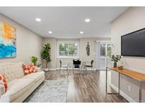 Bright living room features hardwood floors, contemporary decor, and ample natural light at 2856 S Kenton Ct, Aurora, CO 80014