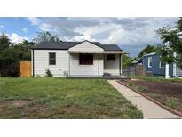 Charming one-story home with a well-maintained lawn and an inviting front porch at 5030 Beach Ct, Denver, CO 80221