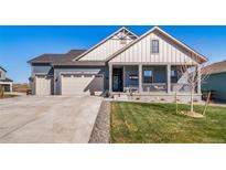 Charming home featuring a welcoming front porch and a well-maintained lawn at 1087 E Hopkins Dr, Elizabeth, CO 80107