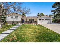 Charming two-story home with beautifully landscaped front yard and welcoming entrance at 6439 E Maplewood Ave, Centennial, CO 80111