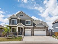 Charming two-story home featuring stone accents, a two-car garage, and a well-manicured lawn at 8346 E 132Nd Dr, Thornton, CO 80602