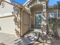 Inviting front exterior featuring a charming covered entryway and attached two-car garage at 9633 Brentwood Way # B, Broomfield, CO 80021