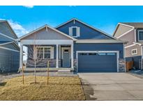 Charming single-Gathering home with blue siding, stone accents, and a two-car garage at 18336 Prince Hill Cir, Parker, CO 80134