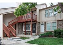 Charming condo with brick facade, private balcony, and inviting entryway at 1128 S Ventura Cir # K, Aurora, CO 80017