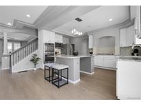 Modern kitchen featuring stainless steel appliances, a kitchen island with seating, and recessed lighting at 2354 Cactus Bloom Ct, Castle Rock, CO 80109