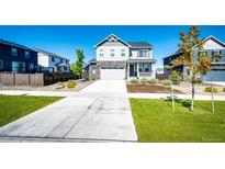 Beautiful two-story home featuring stone accents, a welcoming front porch, and well-manicured lawn at 129 S Waterloo St, Aurora, CO 80018