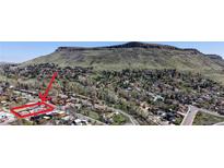 Scenic aerial view of a charming neighborhood nestled in the foothills of a mountain range at 602 5Th St, Golden, CO 80403