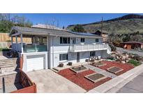 Inviting multi-level home with a large front porch and a well-maintained front yard with mature landscaping at 602 5Th St, Golden, CO 80403