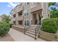 Inviting condo exterior with well-maintained landscaping and a welcoming entrance at 5765 W Atlantic Pl # 104, Lakewood, CO 80227