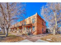 Charming red brick apartment building with covered entrances and well-maintained landscaping at 707 27Th St, Denver, CO 80205
