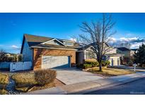 Charming two-story home with a brick facade and well-manicured landscaping at 20576 E Caley Dr, Centennial, CO 80016