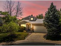 Charming home featuring a manicured lawn, mature trees, and a two-car garage at 12555 Eastlake Dr, Thornton, CO 80241