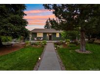Charming single-story home with a landscaped front yard, walkway, and cozy front porch seating area at 403 Anderson St, Castle Rock, CO 80104