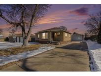 Ranch style home with a spacious driveway and mature trees at 2584 S Utica St, Denver, CO 80219