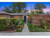 Charming brick home featuring lush landscaping and a welcoming front entrance and walkway at 1335 Jasmine St, Denver, CO 80220