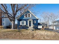Charming blue two-story home with a welcoming front porch and classic architectural details at 5103 Quitman St, Denver, CO 80212