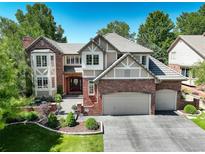Inviting two-story home featuring a three-car garage and manicured front yard at 11904 W Auburn Dr, Denver, CO 80228